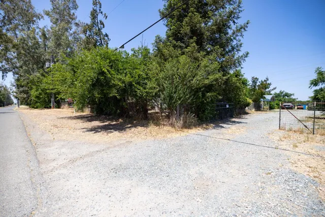 a view of wooden fence and trees around