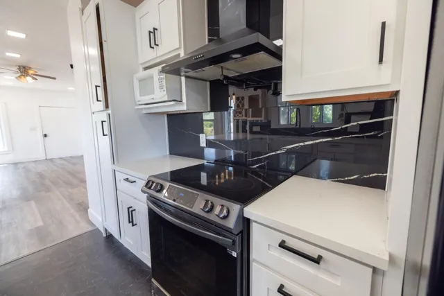 a stove top oven sitting inside of a kitchen
