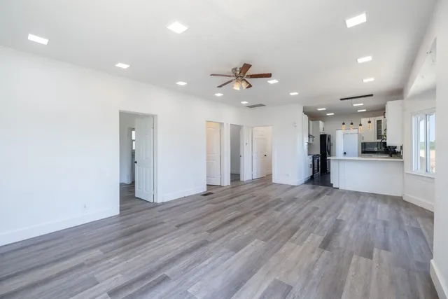 a view of a kitchen with a sink and a refrigerator