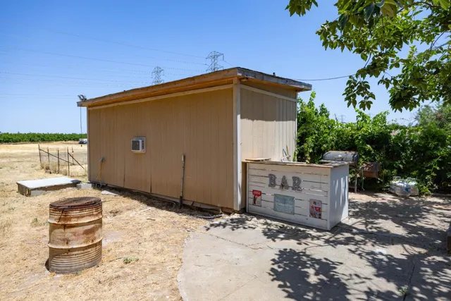 a view of backyard with a table and chairs and potted plants