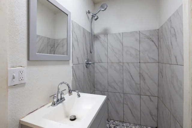 a view of a terrace with a bench and some trees