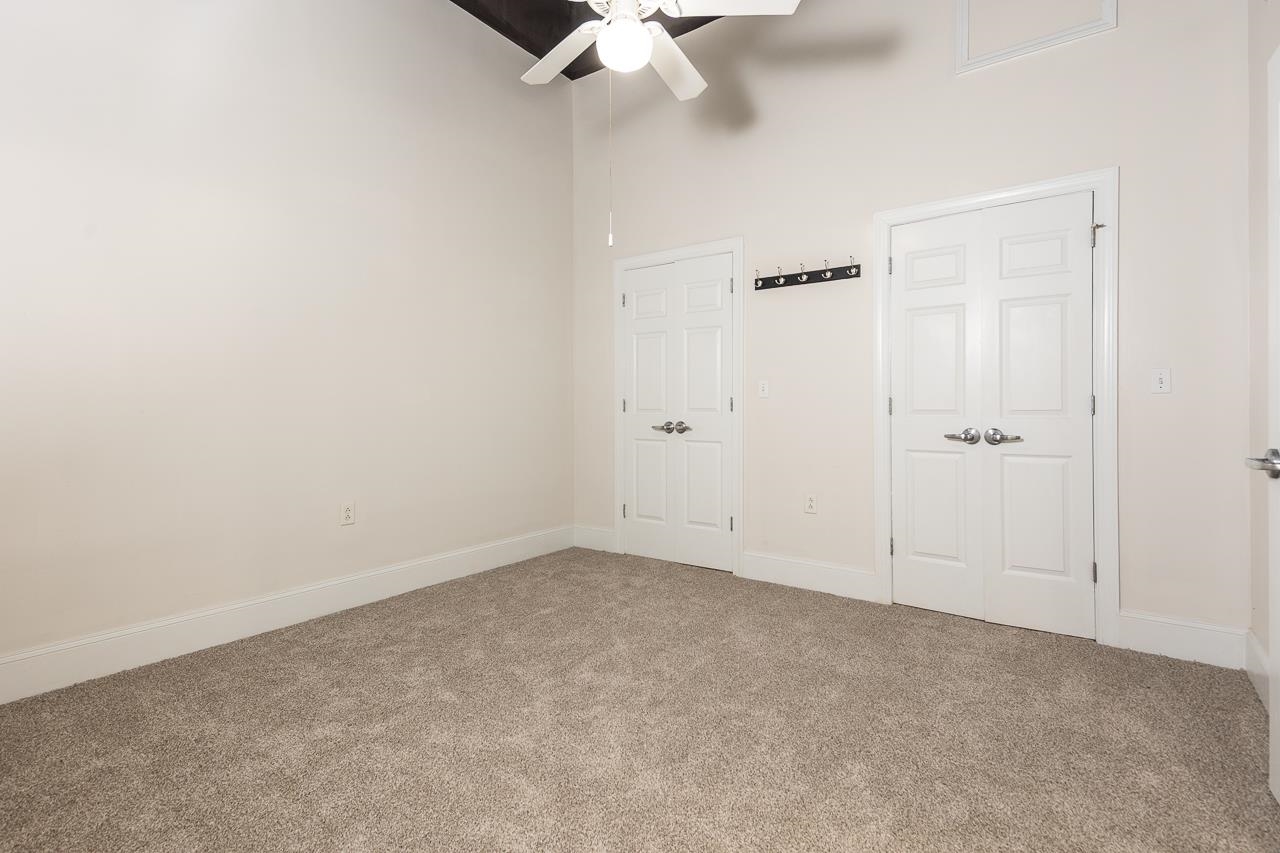 95 South Main Street, Unit 101 Memphis, TN 38103 - Photo 12 of 26 an empty room with a ceiling fan and a window