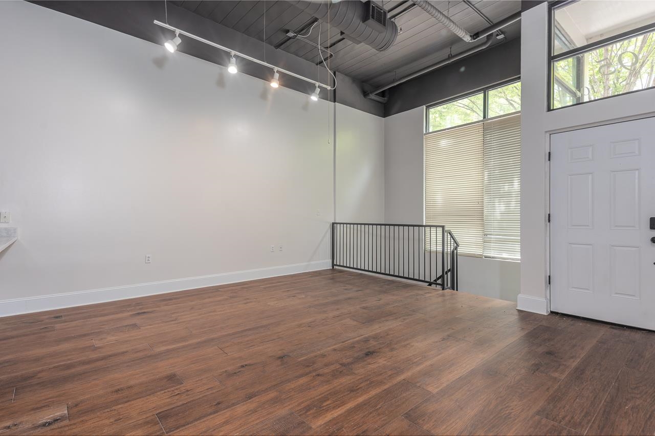 95 South Main Street, Unit 101 Memphis, TN 38103 - Photo 20 of 26 an empty room with wooden floor and windows
