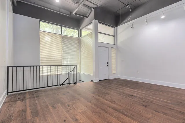 a view of hallway with wooden floor