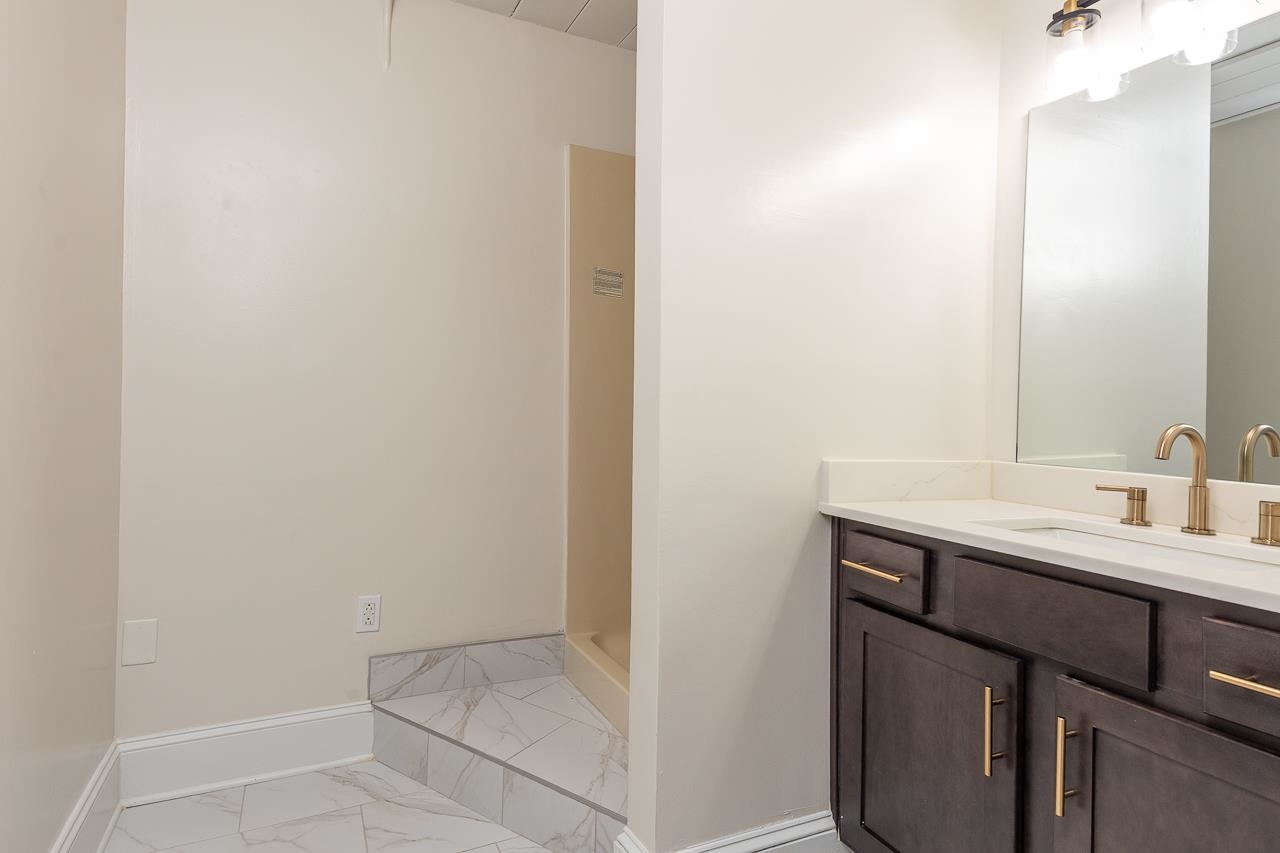 95 South Main Street, Unit 101 Memphis, TN 38103 - Photo 25 of 26 a bathroom with a sink and a mirror