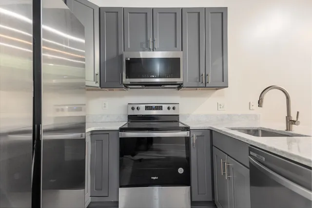 a kitchen with a sink and a stove top oven