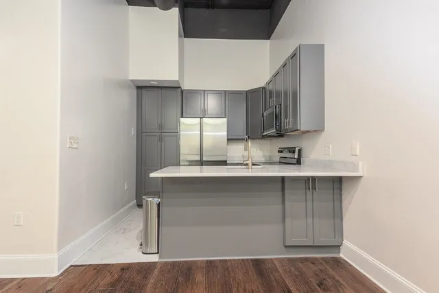 a kitchen with stainless steel appliances a sink and cabinets