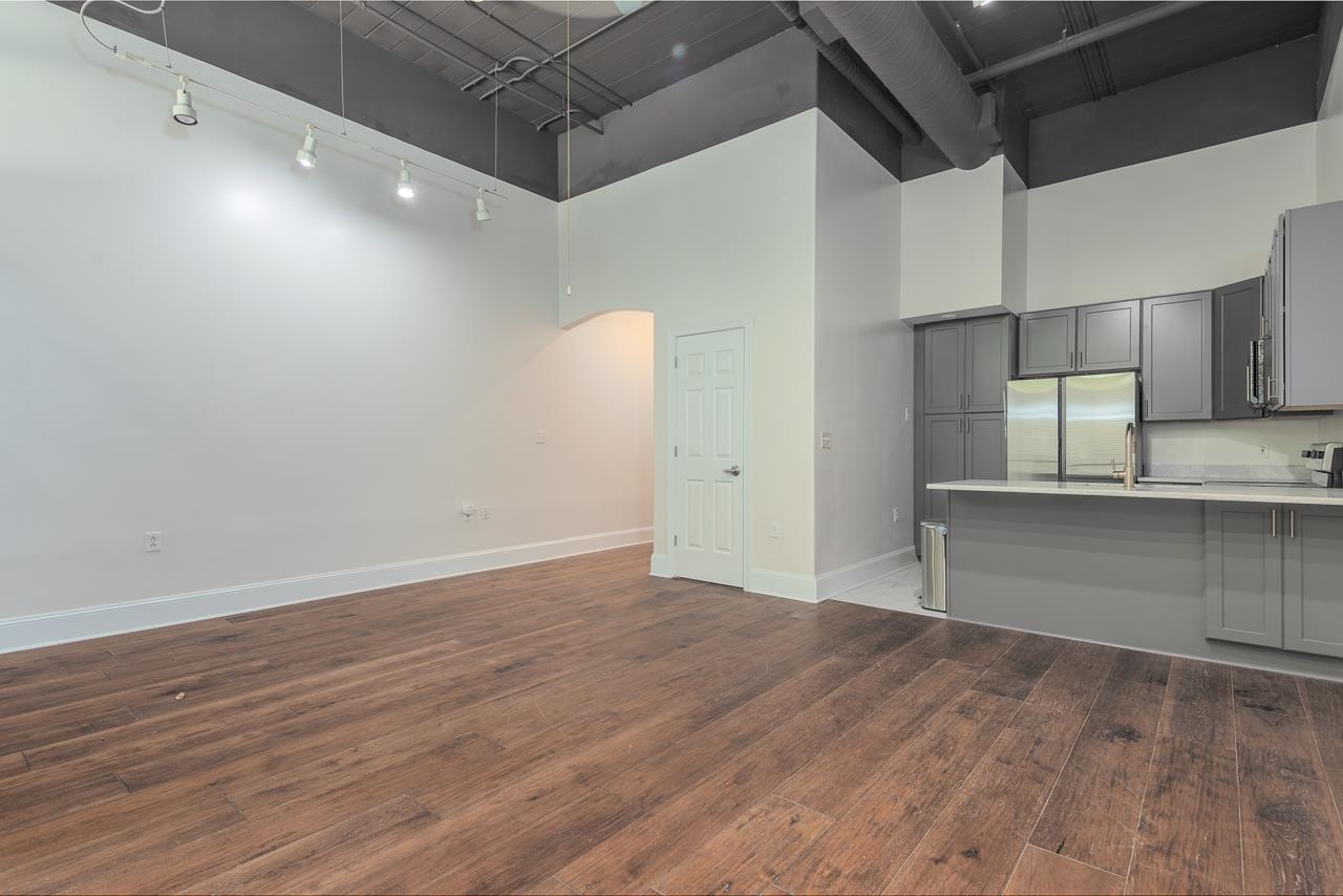 95 South Main Street, Unit 101 Memphis, TN 38103 - Photo 8 of 26 a view of a kitchen with wooden floor and cabinets