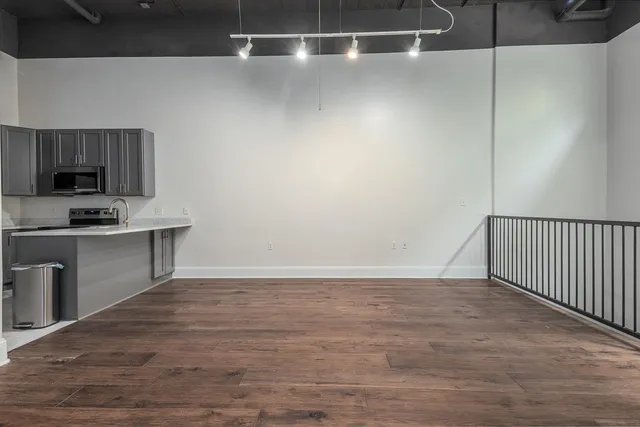 a view of a kitchen with a sink and a refrigerator