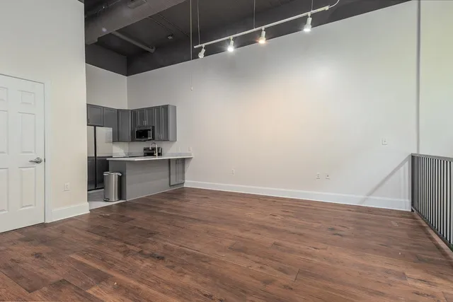 a view of kitchen with microwave and cabinets
