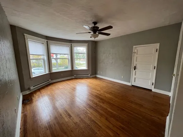 wooden floor in an empty room with a window