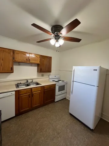 a kitchen with a refrigerator sink and stove