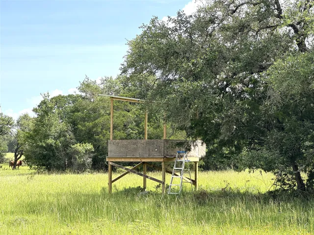 a view of lake with table and chairs