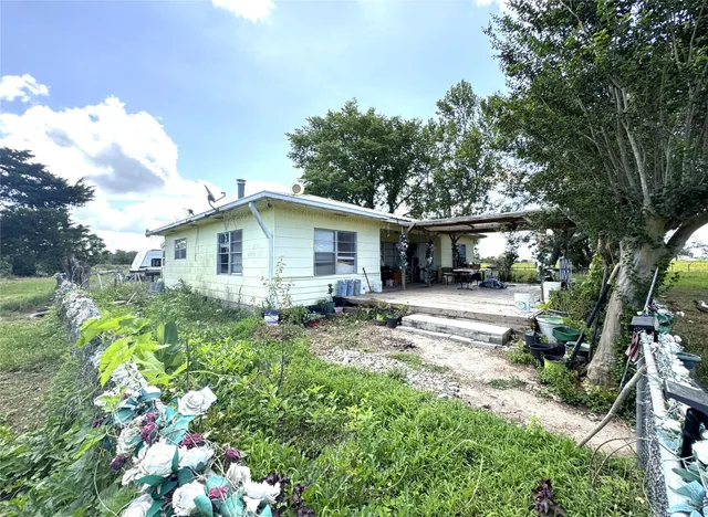 a view of a house with yard and sitting area