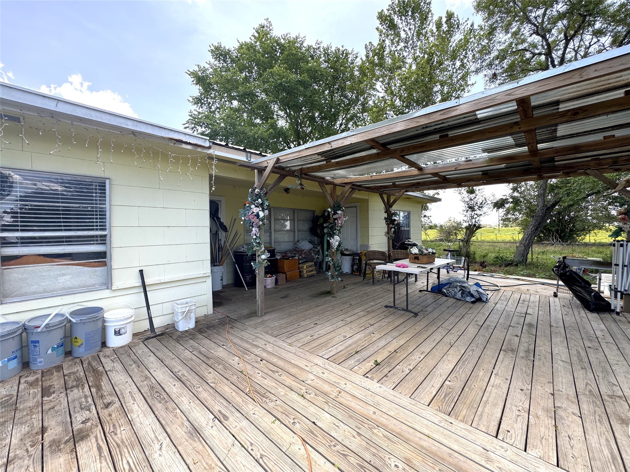 1435 Shaws Bend Road Columbus, TX 78934 - Photo 5 of 36 a view of a deck with table and chairs barbeque with wooden floor and bench