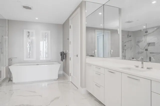 a bedroom with a bed and painting on the wall