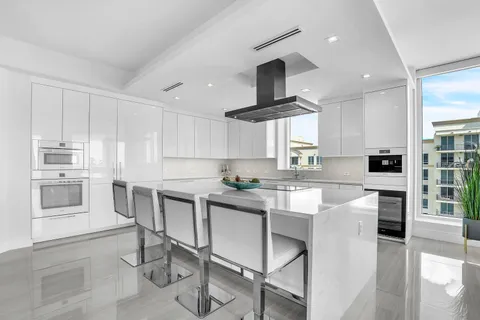 a kitchen with stainless steel appliances kitchen island granite countertop a sink and cabinets