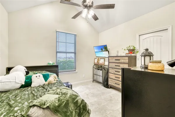 a bedroom with a bed and dresser with mirror