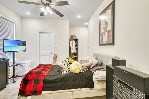 a bedroom with a bed and a lamp