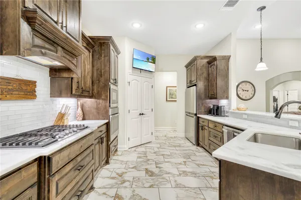 a kitchen with a sink stove and refrigerator