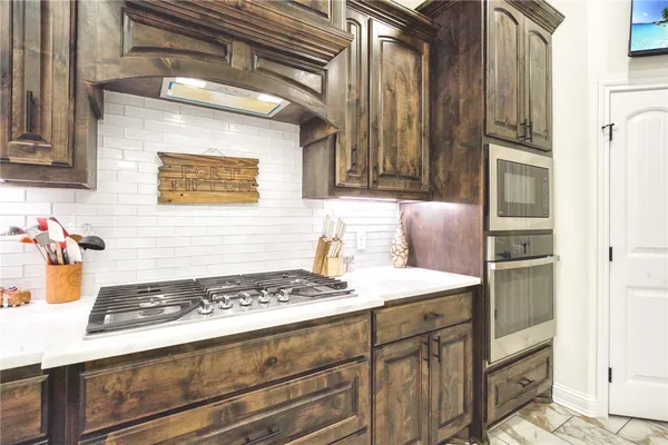 a kitchen with a stove and a refrigerator