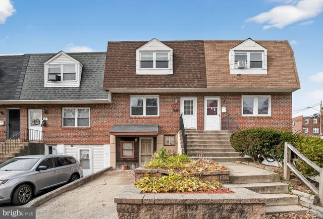 a view of a car parked in front of a brick house