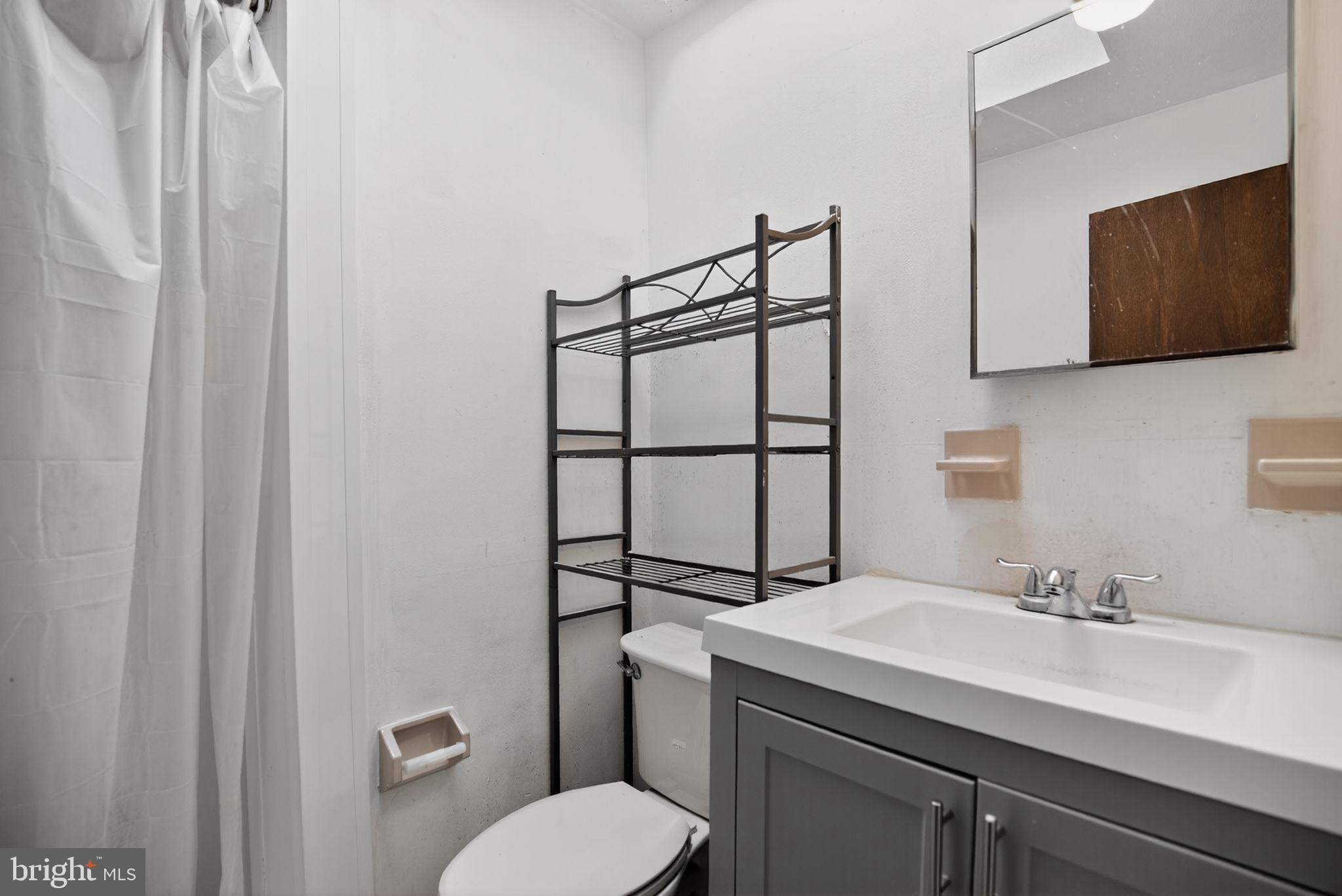 1403 Rainer Road Brookhaven, PA 19015 - Photo 16 of 25 a bathroom with a sink toilet and mirror