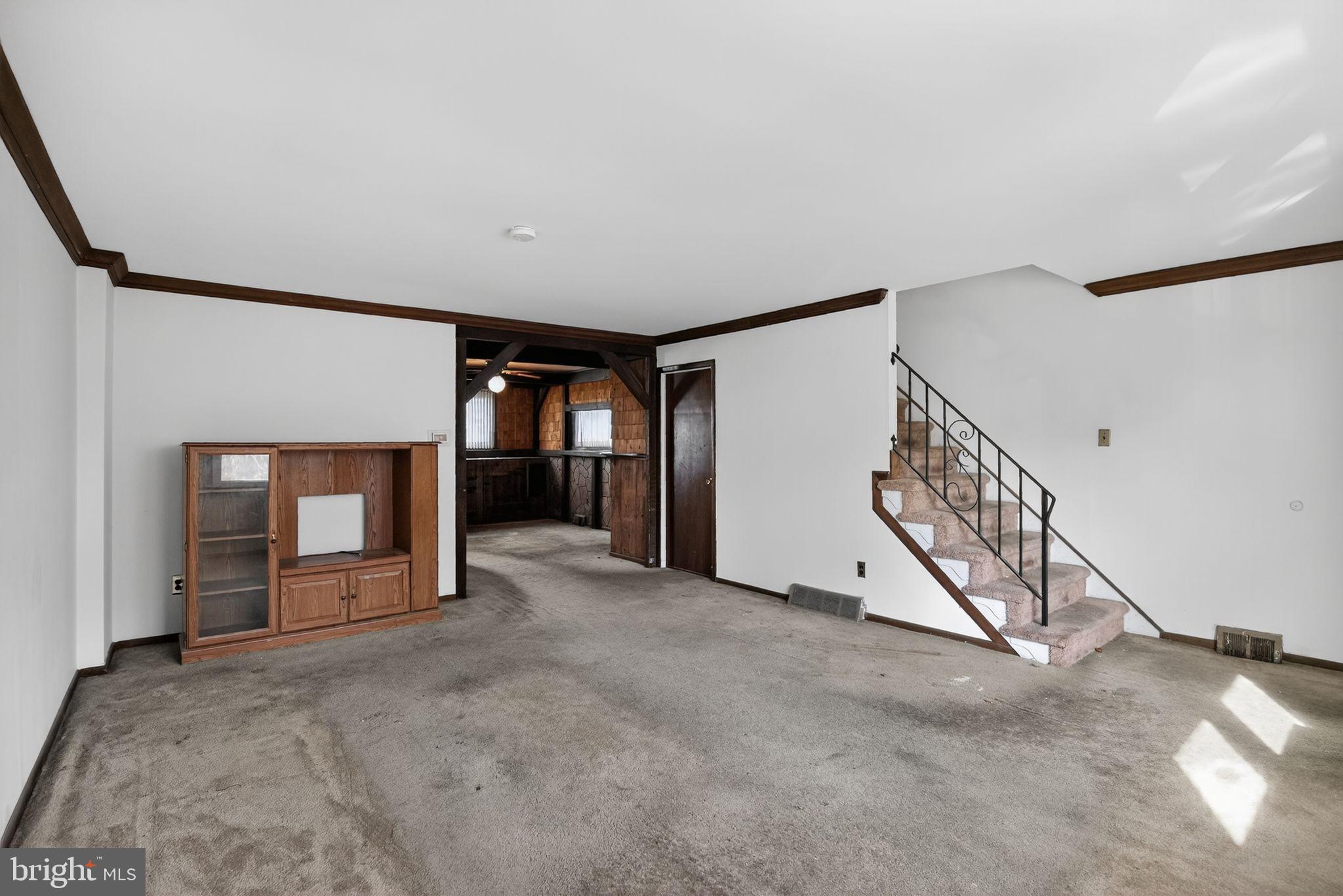 1403 Rainer Road Brookhaven, PA 19015 - Photo 4 of 25 a view of an empty room with a fireplace and a window