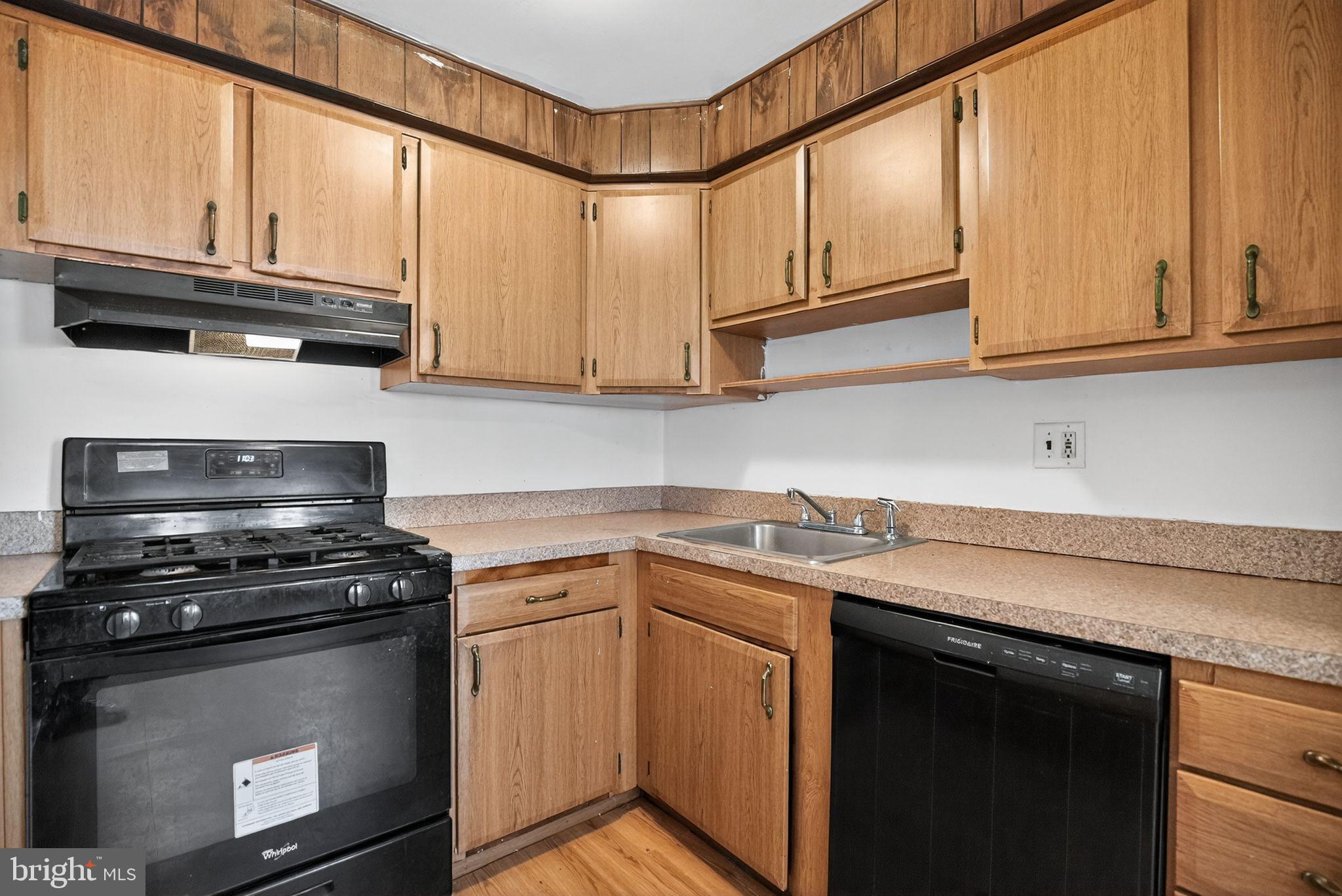 1403 Rainer Road Brookhaven, PA 19015 - Photo 8 of 25 a kitchen with stainless steel appliances granite countertop a sink a stove and cabinets