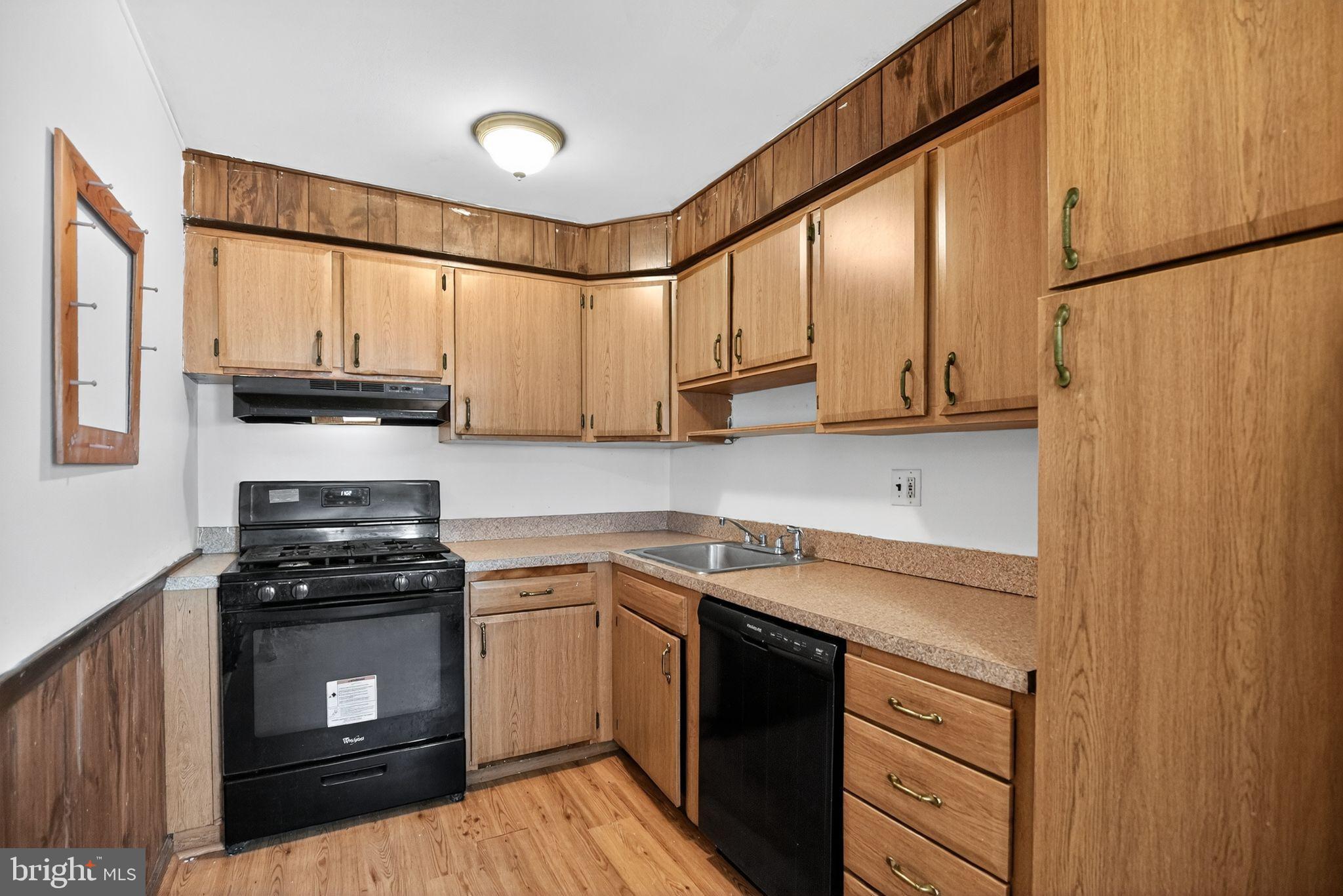 1403 Rainer Road Brookhaven, PA 19015 - Photo 9 of 25 a kitchen with stainless steel appliances granite countertop a stove a sink and a refrigerator