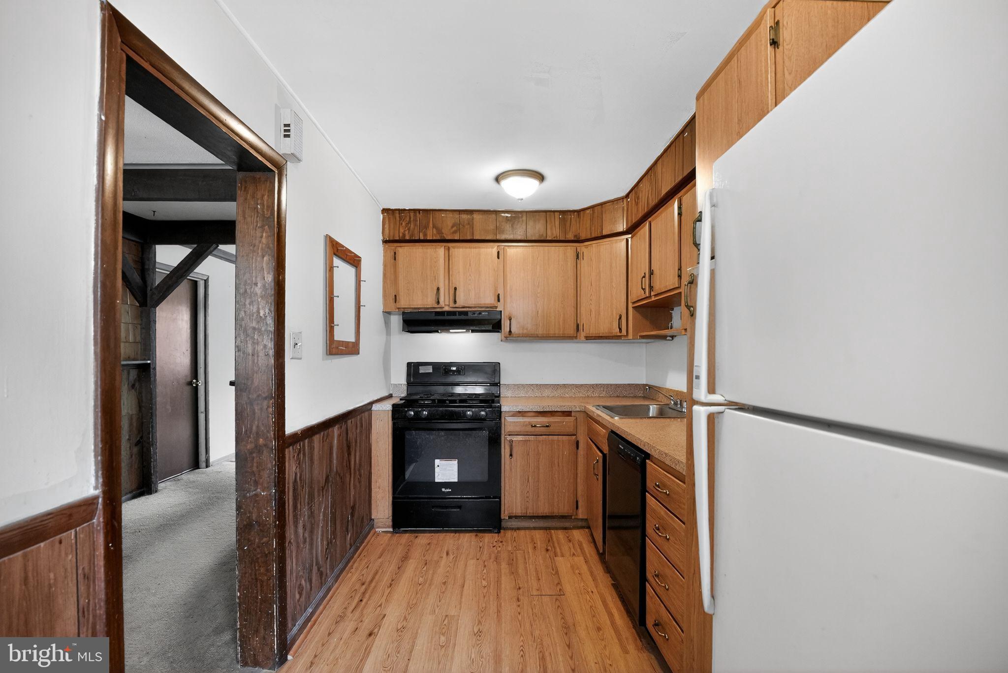 1403 Rainer Road Brookhaven, PA 19015 - Photo 10 of 25 a kitchen with stainless steel appliances granite countertop a refrigerator and a sink