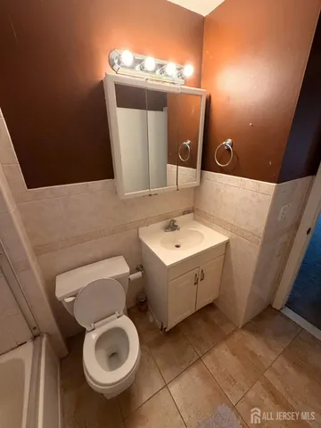 a bathroom with a sink mirror vanity and toilet