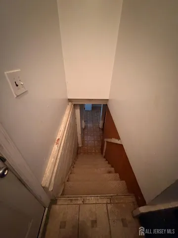 a living room with furniture and a refrigerator