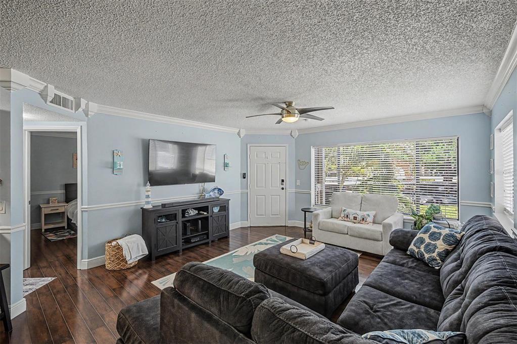 1550 South Belcher Road, Unit 525 Clearwater, FL 33764 - Photo 7 of 28 a living room with furniture and a flat screen tv