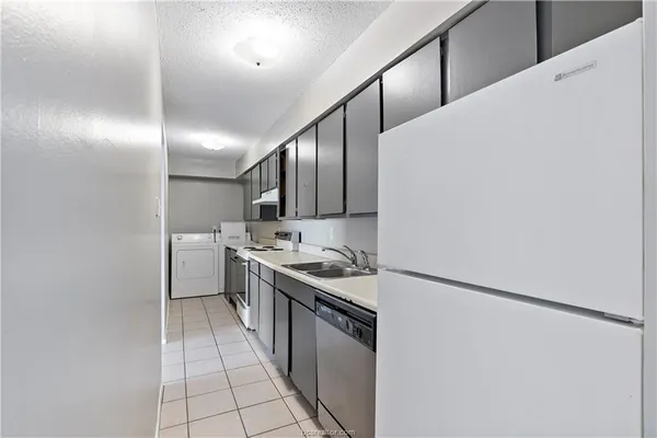 a kitchen with stainless steel appliances granite countertop a sink and a stove
