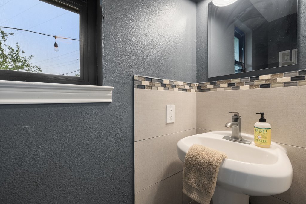 302 South Schramm Road Granger, TX 76530 - Photo 23 of 33 a bathroom with a sink and a mirror