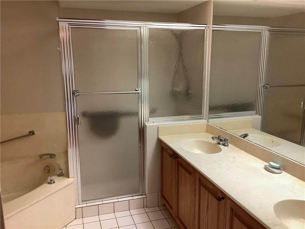 7904 Mansfield Hollow Road Delray Beach, FL 33446 - Photo 16 of 27 a bathroom with a shower sink and mirror