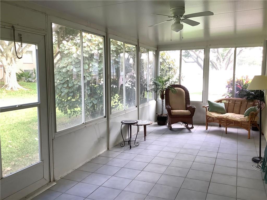 7904 Mansfield Hollow Road Delray Beach, FL 33446 - Photo 19 of 27 a living room with furniture and a floor to ceiling window
