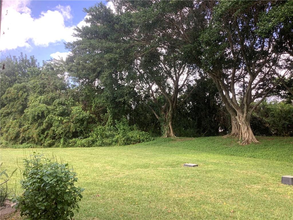 7904 Mansfield Hollow Road Delray Beach, FL 33446 - Photo 24 of 27 a view of outdoor space with a garden and trees