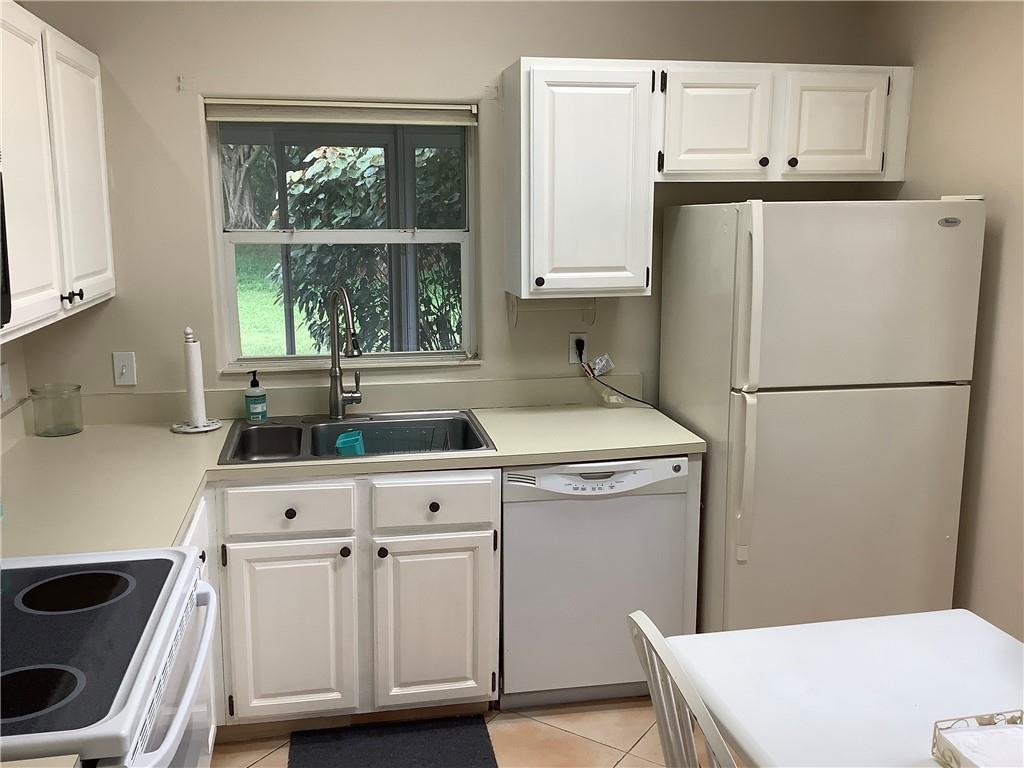 7904 Mansfield Hollow Road Delray Beach, FL 33446 - Photo 4 of 27 a white refrigerator freezer sitting inside of a kitchen