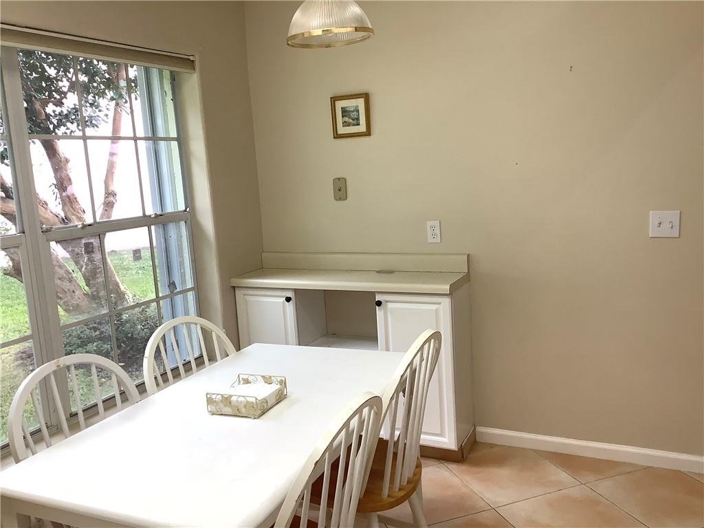 7904 Mansfield Hollow Road Delray Beach, FL 33446 - Photo 6 of 27 a kitchen with a table chairs and a window