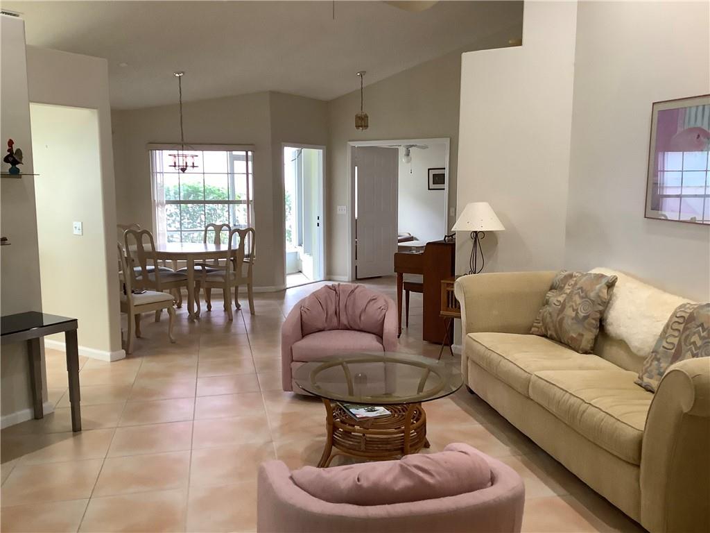 7904 Mansfield Hollow Road Delray Beach, FL 33446 - Photo 8 of 27 a living room with furniture and a large window