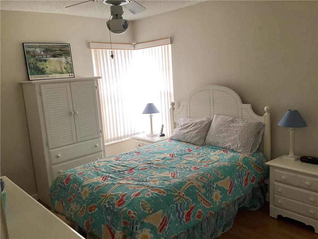 7904 Mansfield Hollow Road Delray Beach, FL 33446 - Photo 10 of 27 a bedroom with a bed and a window