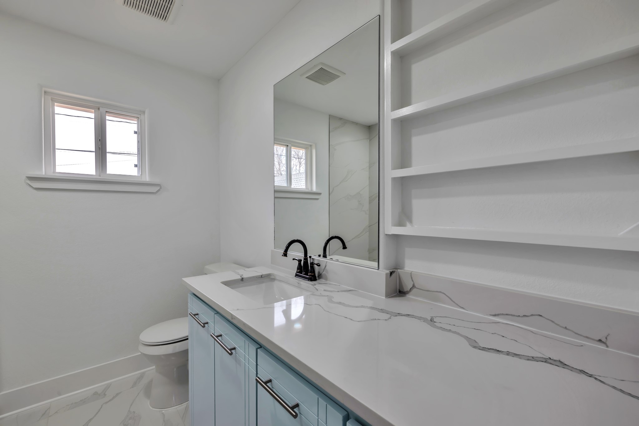 8709 Tarbell Road Houston, TX 77034 - Photo 11 of 25 a bathroom with a double vanity sink toilet and a window