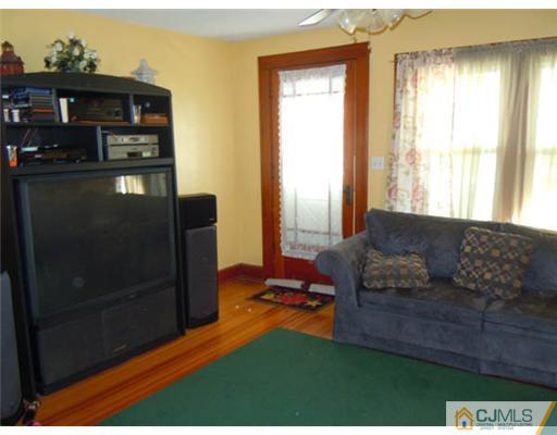 346 Ridge Road Dayton, NJ 08810 - Photo 2 of 12 a living room with furniture and a fireplace