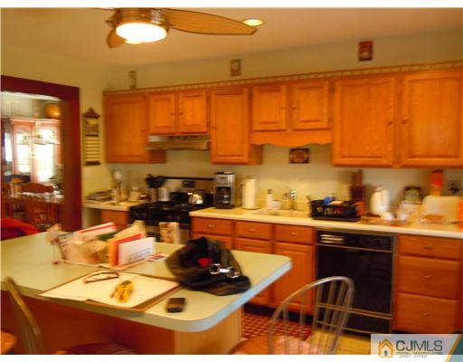 346 Ridge Road Dayton, NJ 08810 - Photo 4 of 12 a kitchen with a sink and a stove next to a window