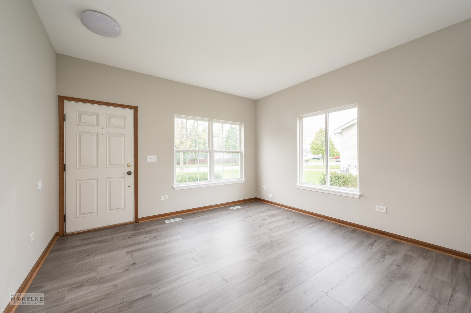 4401 Cummins Street Plano, IL 60545 - Photo 5 of 22 an empty room with wooden floor and windows