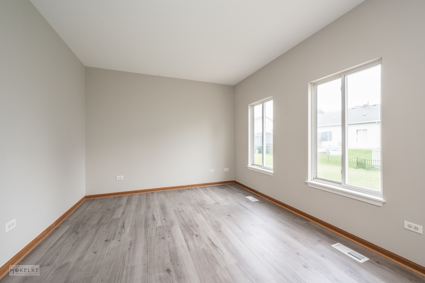 4401 Cummins Street Plano, IL 60545 - Photo 7 of 22 an empty room with wooden floor and windows