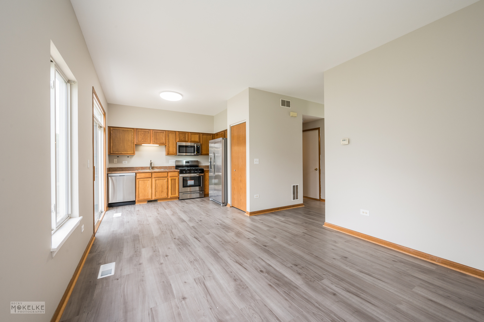 4401 Cummins Street Plano, IL 60545 - Photo 8 of 22 a view of a kitchen with wooden floor and a sink