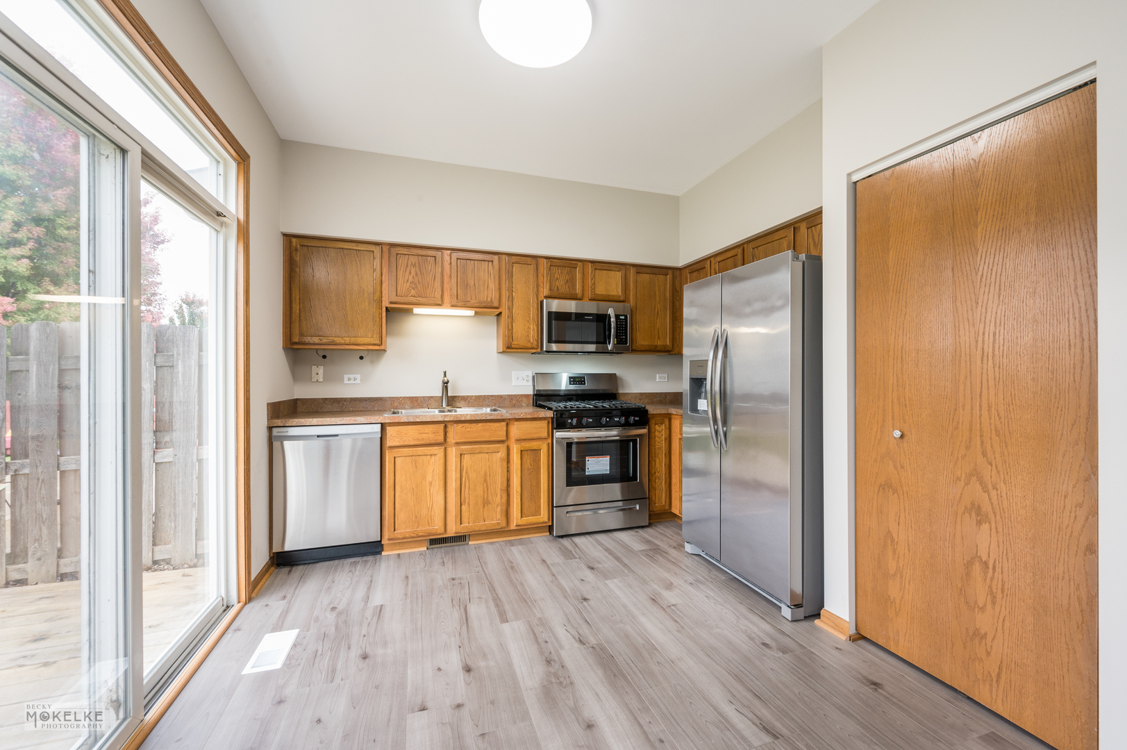 4401 Cummins Street Plano, IL 60545 - Photo 9 of 22 a kitchen with a refrigerator and a stove top oven